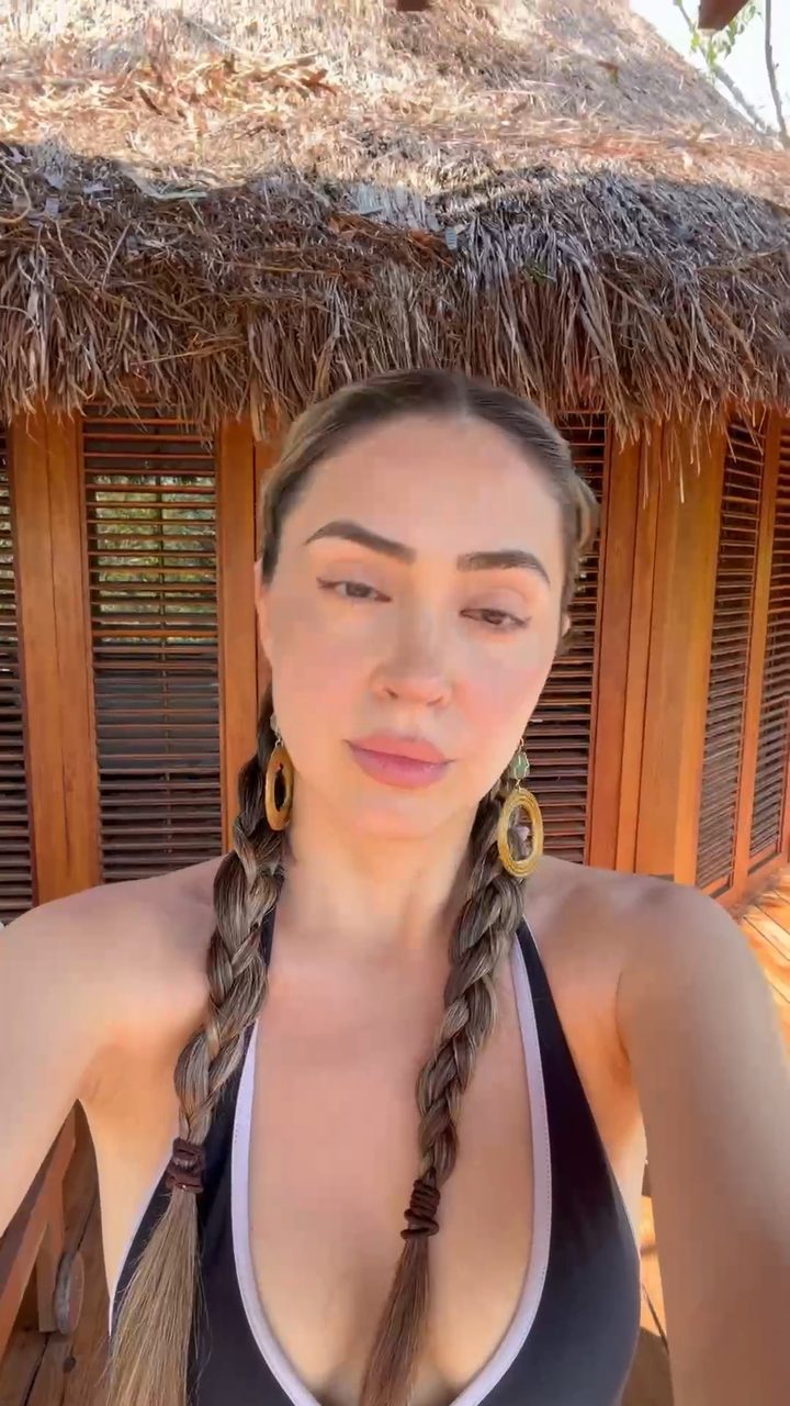 Gaye del Sol outdoors in daylight, hair braided, bare skin